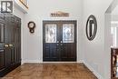 Foyer featuring dual entry doors with decorative glass inserts, ceramic tile flooring, and a paneled closet door - 26 Shadyridge Place, Kitchener, ON 