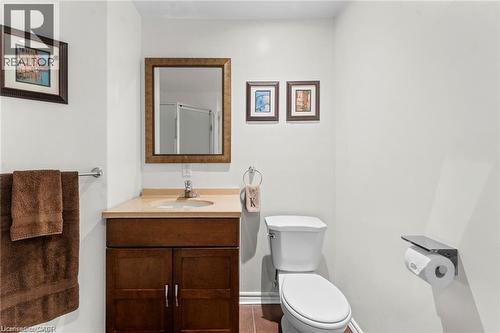 Bathroom featuring a brown wood-finish vanity with a light-toned countertop and an undermount sink - 26 Shadyridge Place, Kitchener, ON 