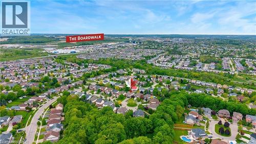 Aerial perspective showcasing a residential neighborhood with abundant mature trees and curving street layouts - 26 Shadyridge Place, Kitchener, ON 