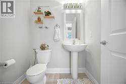 Pedestal sink with a framed mirror and three-bulb vanity light - 