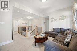 Upper-level landing featuring a staircase with wood handrails and black balusters - 
