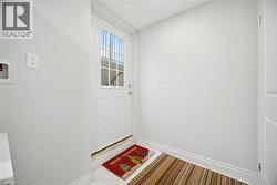 White paneled door with integrated window, featuring grid detailing and a chrome door handle - 