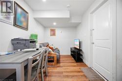 Interior space featuring wood-finish flooring, white walls, and recessed lighting - 