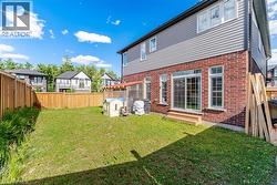 Rear exterior featuring a brick and siding facade - 