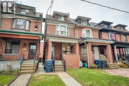 Brick exterior featuring a gabled dormer and bay window - 41 Springhurst Avenue, Toronto, ON 