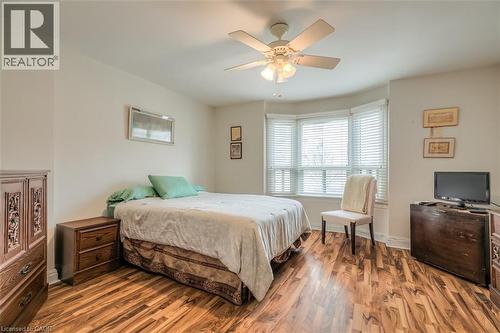 Room featuring wood-finish flooring, a bay window with blinds, and an overhead ceiling fan - 41 Springhurst Avenue, Toronto, ON 