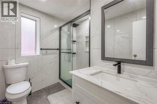 Contemporary bathroom featuring a white vanity with integrated sink, a framed mirror, and a walk-in shower with glass enclosure - 41 Springhurst Avenue, Toronto, ON 