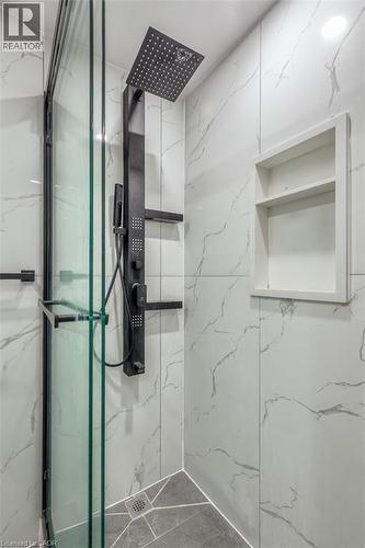 Shower enclosure featuring a matte black rain shower head, hand-held shower, and body jets - 41 Springhurst Avenue, Toronto, ON 