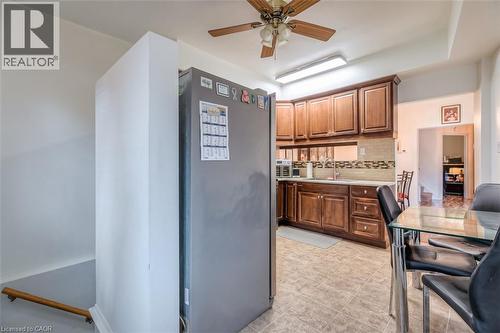 Kitchen featuring wood cabinetry, light countertops, and a tiled backsplash - 41 Springhurst Avenue, Toronto, ON 