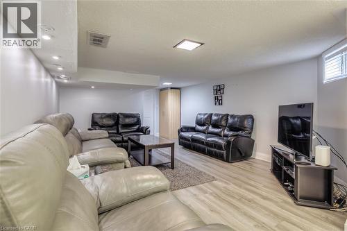 Finished living area with recessed lighting, light wood-finish flooring, and a window with blinds - 41 Springhurst Avenue, Toronto, ON 