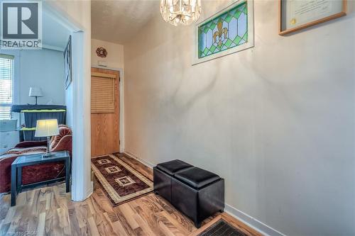 Entryway featuring wood-finish flooring, a wood door with horizontal blinds, and a decorative stained-glass window - 41 Springhurst Avenue, Toronto, ON 