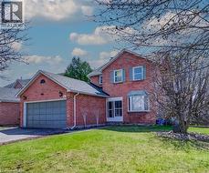 Brick exterior featuring a two-car garage, bay window, and gabled roofline - 