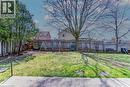 Expansive grassy yard featuring mature trees and a wooden privacy fence - 27 Tassie Lane, Cambridge, ON 