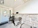 Front entry with a white door featuring an oval decorative glass insert and a sidelight with stained glass - 3135 Palmer Drive, Burlington, ON 