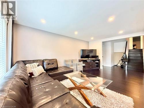 Spacious living area featuring rich wood-finish flooring and recessed lighting - 3135 Palmer Drive, Burlington, ON 