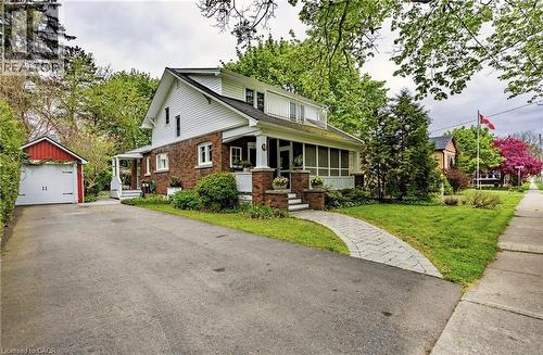 1 1/2 wide paved driveway, detached single car garage, side covered porch and interlocking brick walkway to the front door and covered screened porch. - 72 Crescent Boulevard, Simcoe, ON - Outdoor With Facade