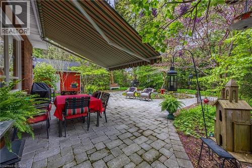 Interlocking brick patio that wraps around the beautiful backyard perennial gardens - 72 Crescent Boulevard, Simcoe, ON - Outdoor With Deck Patio Veranda
