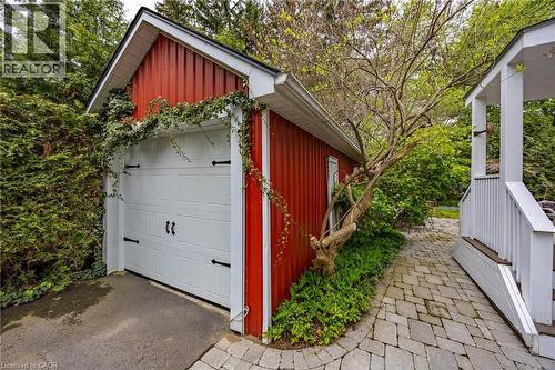 Single car detached garage and updated covered side-door porch wiith composite deck and steps - 72 Crescent Boulevard, Simcoe, ON - Outdoor With Exterior
