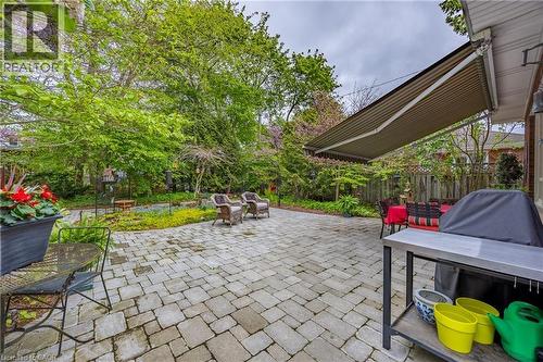Backyard with interlocking brick patio and garden path - 72 Crescent Boulevard, Simcoe, ON - Outdoor With Deck Patio Veranda