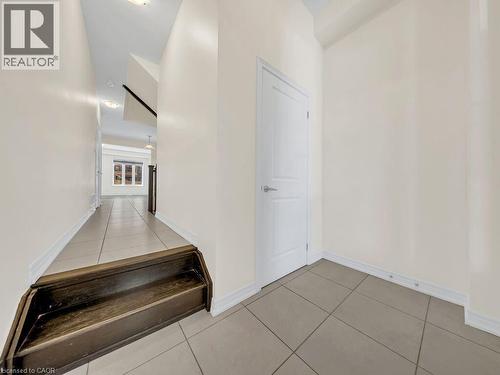 Entrance area featuring neutral wall paint, tile flooring, and white trim - 76 Grassbourne Avenue, Kitchener, ON 