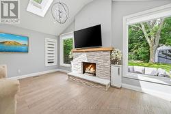 Family Room Offers a Vaulted Ceiling w/Skylights - 