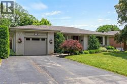 Brick exterior with an attached garage and asphalt driveway - 
