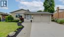 Front exterior with stone facade and horizontal siding - 127 Strathcona Crescent, Kitchener, ON 