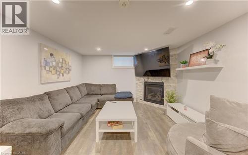 Finished living space featuring wood-finish flooring and recessed lighting - 127 Strathcona Crescent, Kitchener, ON 