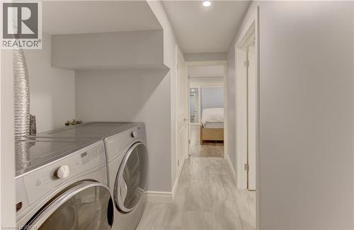 Dedicated laundry area featuring a front-loading washer and dryer set - 127 Strathcona Crescent, Kitchener, ON 