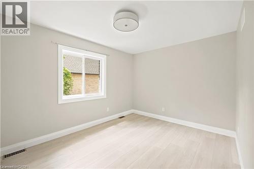 Bright room featuring light-toned walls and wood-finish flooring - 129 St George Street, Kitchener, ON 
