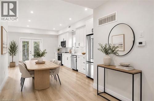 Open-concept living space featuring wood-finish flooring and recessed lighting - 129 St George Street, Kitchener, ON 