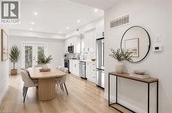 Open-concept living space featuring wood-finish flooring and recessed lighting - 