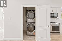 Dedicated laundry area featuring stacked appliances - 