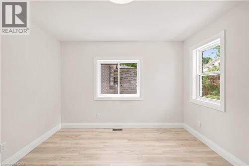 Bright interior space featuring light-toned wall paint, white trim, and wood-finish flooring - 131 St George Street, Kitchener, ON 