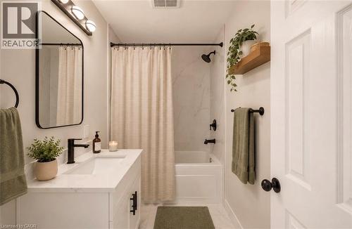 Bathroom featuring a white vanity with an integrated sink and matte black fixtures - 131 St George Street, Kitchener, ON 