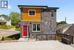 Modern facade featuring dark stone cladding and wood-finish paneling - 