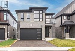 Contemporary exterior with light gray brick and dark siding accents - 