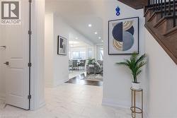 White tile flooring with subtle veining throughout the entryway - 