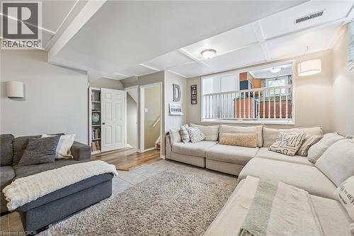 Spacious living area featuring a coffered ceiling and recessed lighting - 24 Byton Lane, Cambridge, ON 
