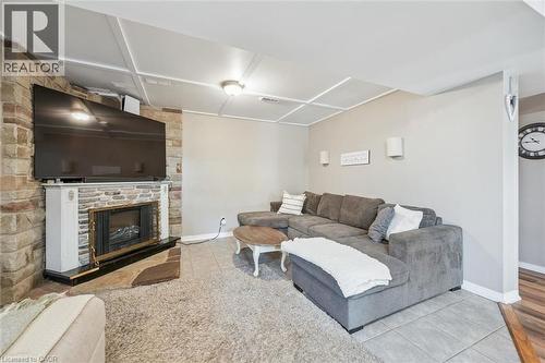 Recessed fireplace with a stone surround and white mantelpiece - 24 Byton Lane, Cambridge, ON 