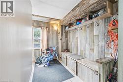 Entryway mudroom featuring distressed wood paneling - 