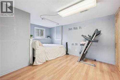 Room featuring wood-finish flooring, a double-pane window, and light blue wall tones - 24 Byton Lane, Cambridge, ON 