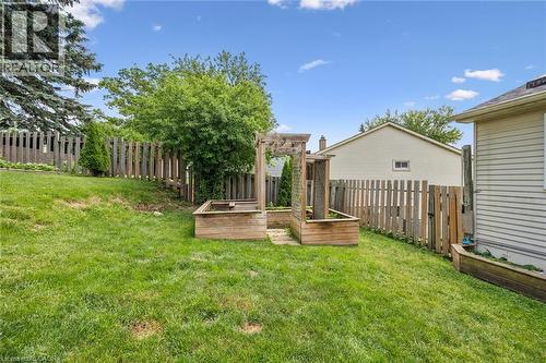 Expansive green lawn with a wooden privacy fence - 24 Byton Lane, Cambridge, ON 