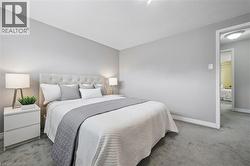 Wall-to-wall carpeting in a neutral tone complements the light grey walls - 