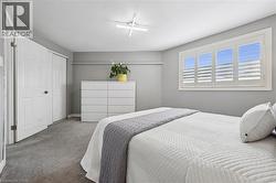 Recessed window featuring white louvered shutters - 