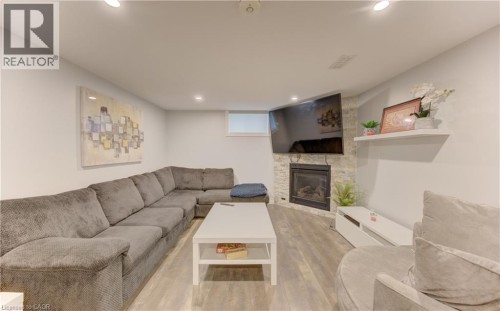Finished living space featuring wood-finish flooring and recessed lighting - 127 Strathcona Crescent, Kitchener, ON 