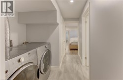 Dedicated laundry area featuring a front-loading washer and dryer set - 