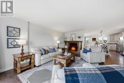 Open living room with fireplace and kitchen view - 