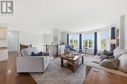 Sunlit living room with large windows - 