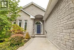 Stone veneer exterior featuring a prominent arched entry - 